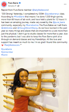 A Pure Barre member celebrating her 500th class, posing with a ballet barre in a studio.