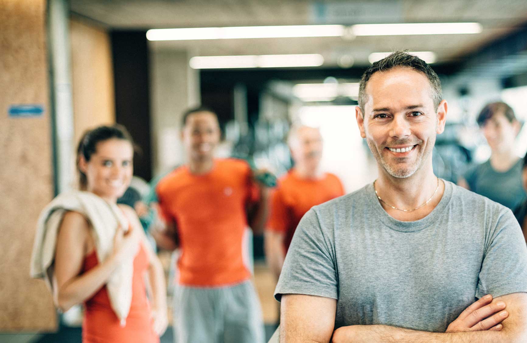 Group fitness instructor leading class at a gym.