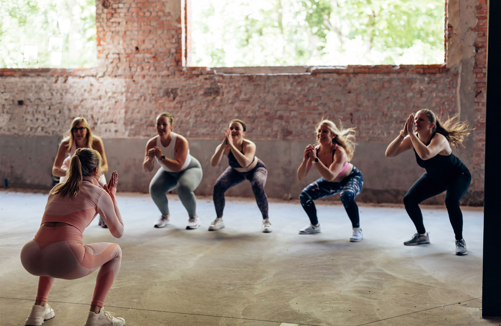 Group fitness class doing squats